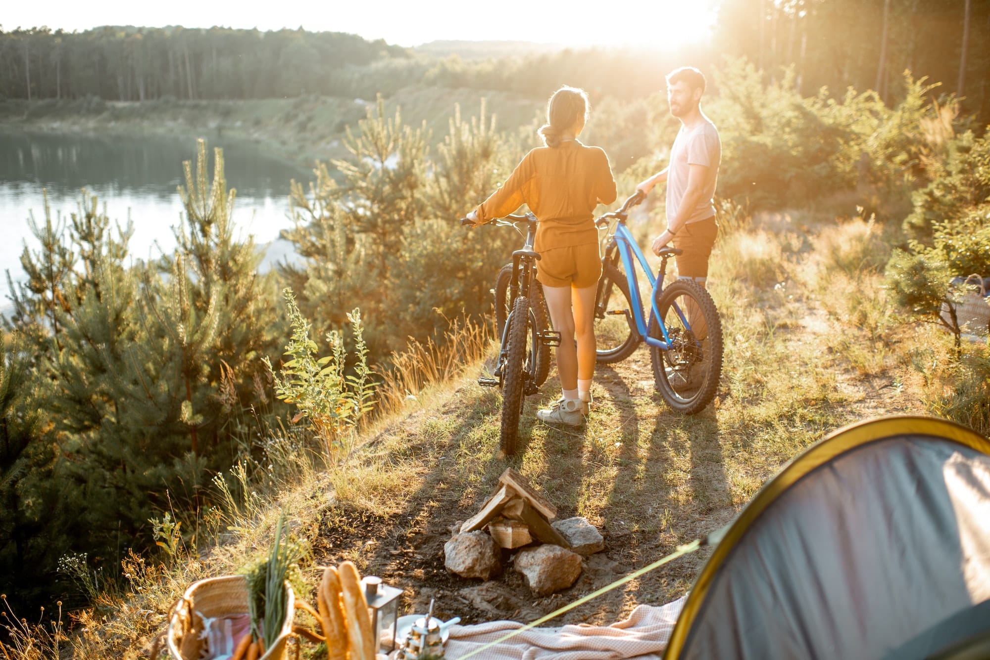 Couple traveling with bicycles and tent in the mountains