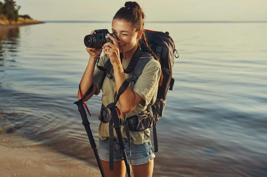 Female photographer taking a picture on coastline